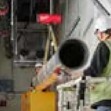 Mechanical contractor installing pipe — from the Fastening House catalog